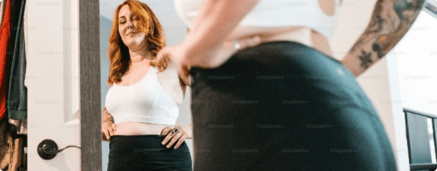 Woman looking at her reflection in a mirror